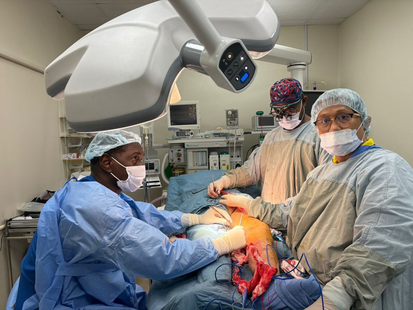 Surgical team performing limb-saving bypass surgery in the operating theatre at Newtown Medical Centre